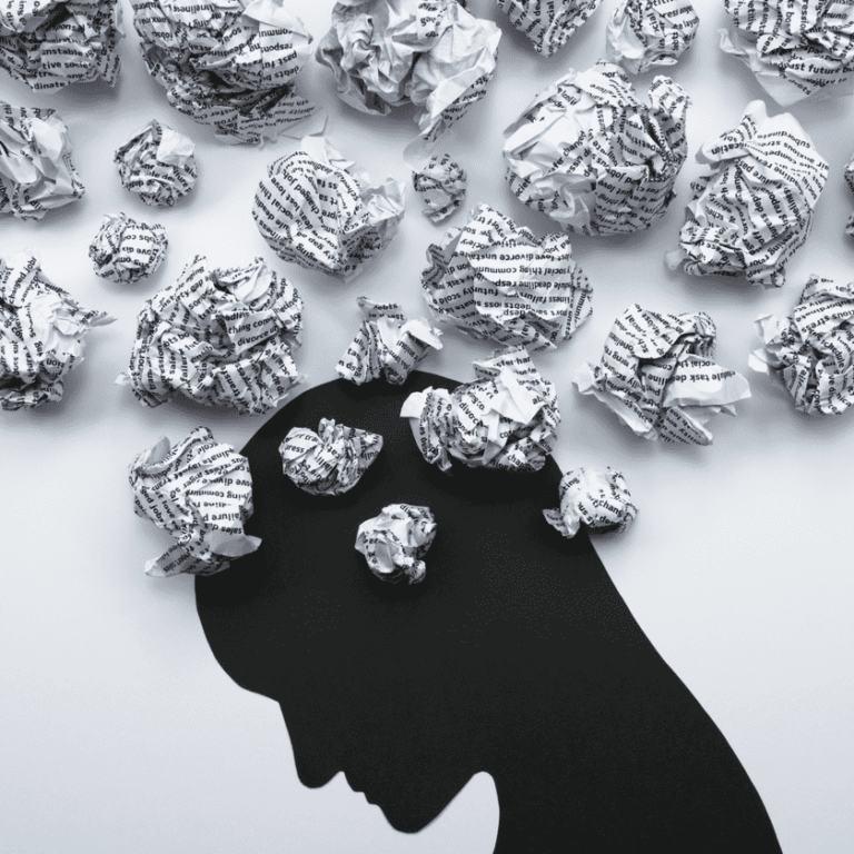 A silhouette of a person's head is depicted, surrounded by crumpled pieces of paper. The composition conveys a sense of chaos or overthinking.